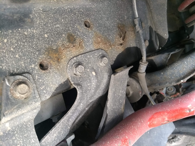 Rusty front frame rail buckled a bit